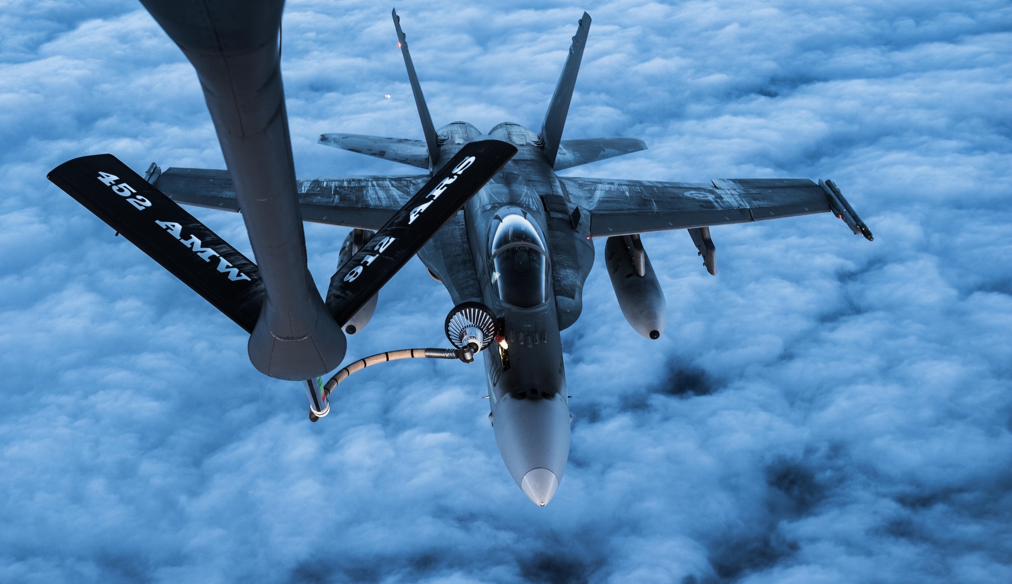 A U.S. Air Force KC-135 Stratotanker flown by the 912th Air Refueling Squadron from March Air Force Base, Calif., provides refueling capabilities to Royal Canadian Air Force CF-18s while both units participate in the Vigilant Shield 2017 Field Training Exercise Oct. 20, 2016, in the high arctic. This exercise provides crucial training opportunities for numerous military personnel with a variety of aircraft and assets from Canada and the United States to improve interoperability and to demonstrate North American Aerospace Defense Command’s ability to defend North America. (U.S. Air Force Photo by Tech. Sgt. Gregory Brook)