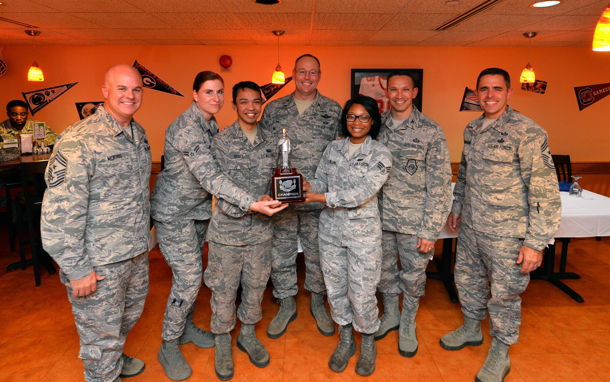 The Iron Chef team representing the Campisi Alert Dining display their trophy with wing leadership from both the 55th and 70th Intelligence, Surveillance and Reconnaissance Wing’s at the Iron Chef Grill Masters competition held hosted at the Ronald L. King Dining Facility on Oct. 13, Offutt Air Force Base, Neb.  The Iron Chef trophy will be displayed in the Alert Kitchen until the next competition where the Campisi team will look to defend their title.  (U.S. Air Force photo by Josh Plueger)