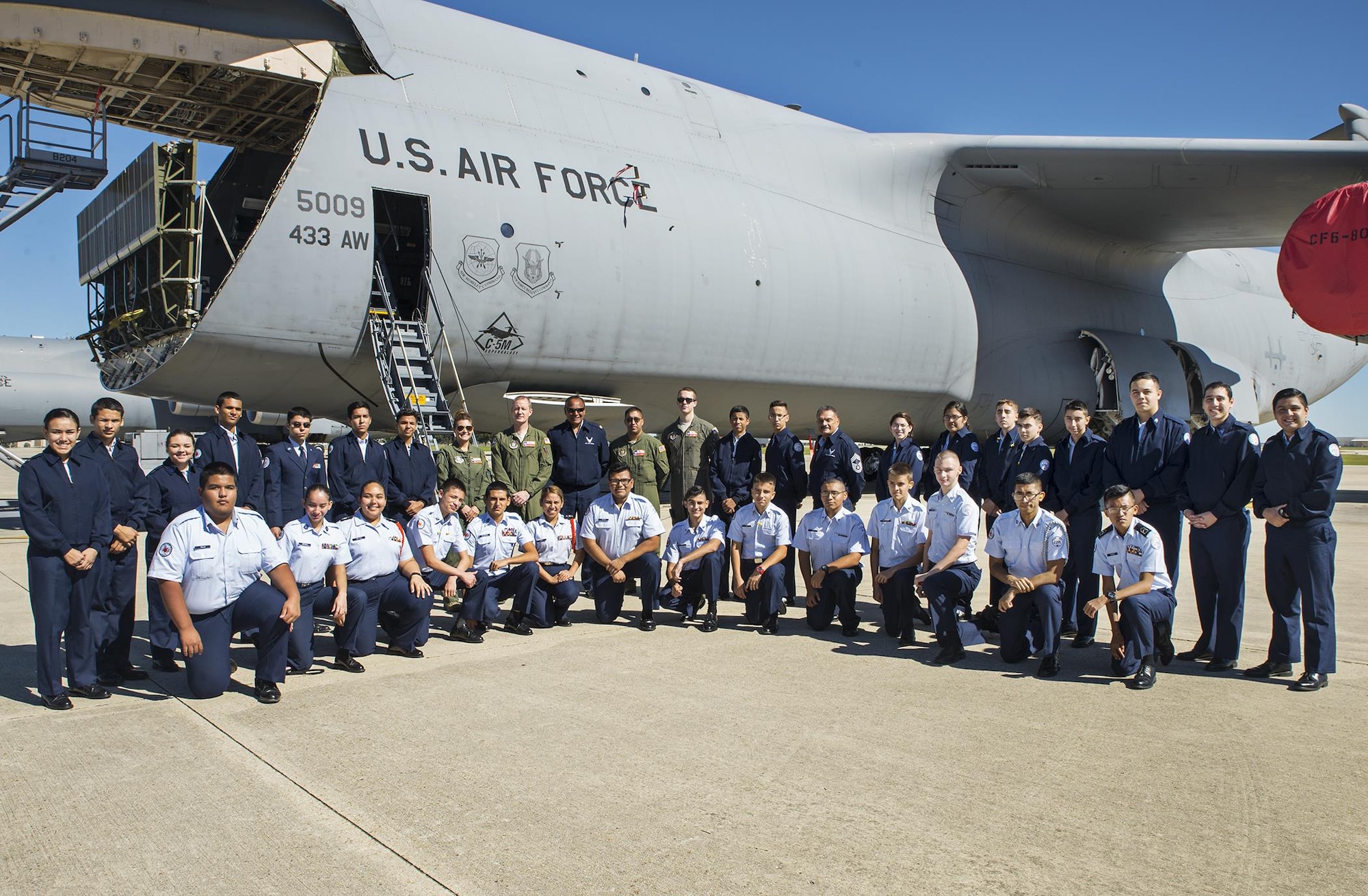 Air Force Junior ROTC students from United High School pose for a group photo in front of a C-5M Super Galaxy aircraft Oct. 21, 2016 at Joint Base San Antonio-Lackland, Texas. Students also watched an Air Force basic training graduation parade, received a 433rd Airlift Wing mission briefing, and had lunch at the Live Oak dining facility on base. (U.S. Air Force photo by Benjamin Faske)