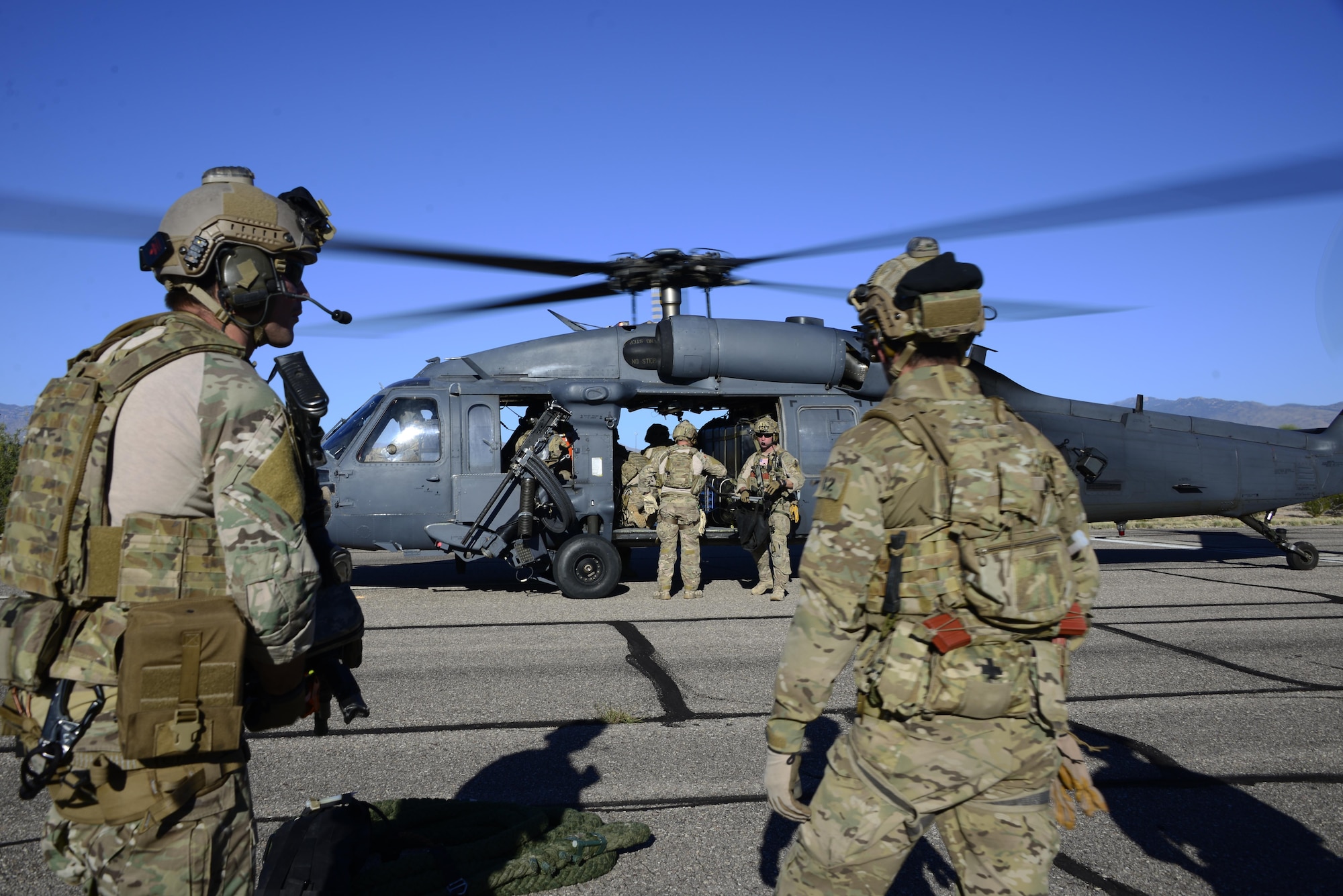Pararescuemen assigned to the 48th Rescue Squadron load gear on an HH-60G Pave Hawk in preparation for alternate insertion/extraction training at Davis-Monthan Air Force Base, Ariz., Oct. 18, 2016.  The 48th RQS deploys worldwide in support of national security objectives and homeland defense, providing highly trained experts capable of quickly and effectively executing personnel recovery operations. (U.S. Air Force photo by Senior Airman Betty R. Chevalier)