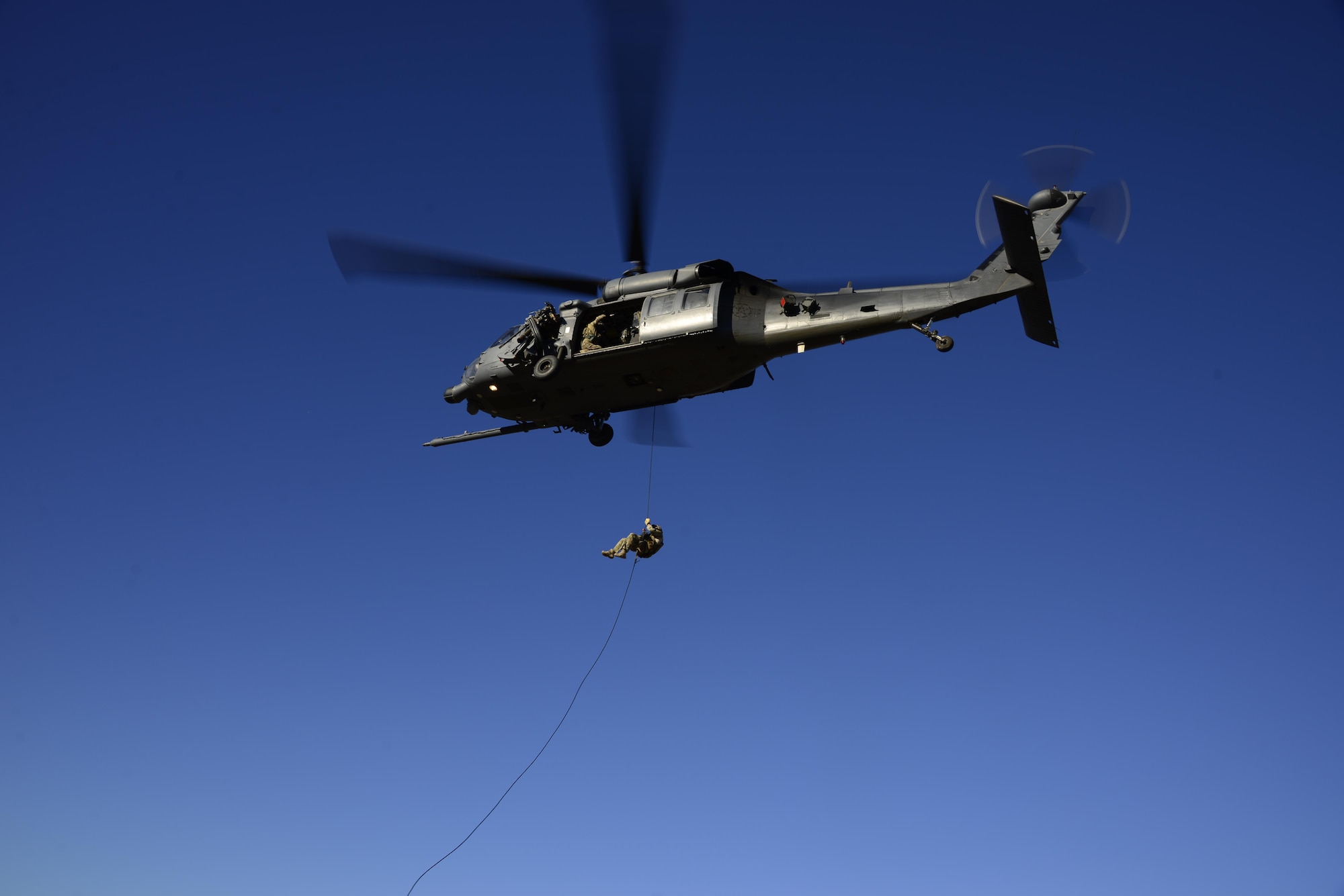 A pararescueman assigned to the 48th Rescue Squadron rappels out of an HH-60G Pave Hawk during alternate insertion/extraction training at Davis-Monthan Air Force Base, Ariz., Oct. 18, 2016.  The four methods that can be used during AIE are fast-rope, rope ladder, rappel and hoist. (U.S. Air Force photo by Senior Airman Betty R. Chevalier)