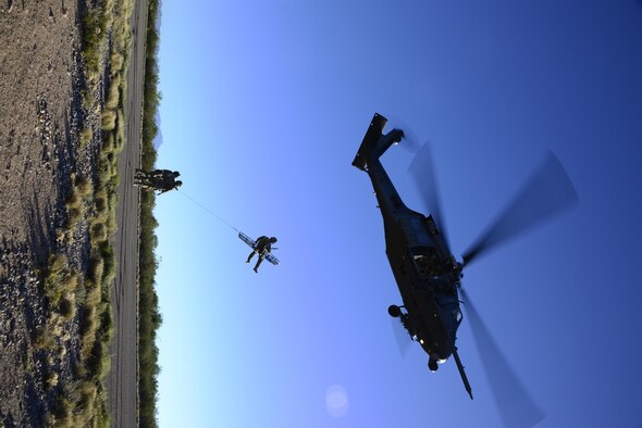 A pararescueman assigned to the 48th Rescue Squadron is hoisted with a stokes litter into an HH-60G Pave Hawk during alternate insertion/extraction training at Davis-Monthan Air Force Base, Ariz., Oct. 18, 2016. AIE methods are utilized when a helicopter is unable to land due to terrain, altitude or other factors. (U.S. Air Force photo by Senior Airman Betty R. Chevalier)