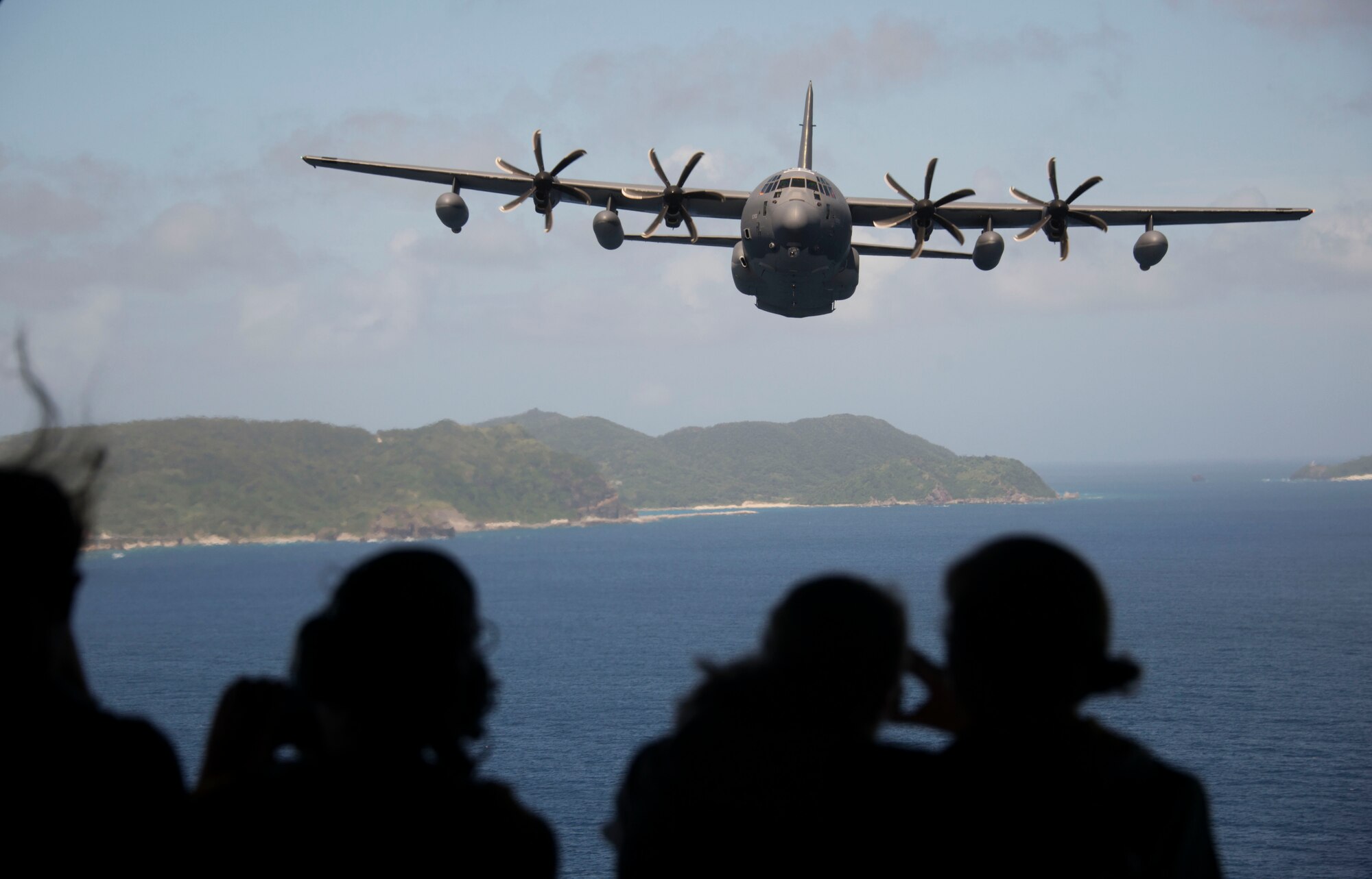 Spouses from the 353rd Special Operations Group look out the back of a MC-130J Commando II during a familiarization flight. The 353rd SOG hosted a day of activities at Kadena Air Base to honor military spouses, Oct. 6, 2016. (U.S. Air Force photo by Capt. Jessica Tait)