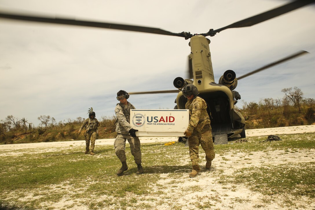 U.S. service members with Joint Task Force Matthew unload supplies from a CH-47 Chinook helicopter at a landing zone at Jeremie, Haiti, Oct. 9, 2016. JTF Matthew, a U.S. Southern Command-directed team deployed to Port-au-Prince at the request of the Government of Haiti, on a mission to provide humanitarian and disaster relief assistance in the aftermath of Hurricane Matthew. (U.S. Marine Corps photo by Cpl. Samuel Guerra)