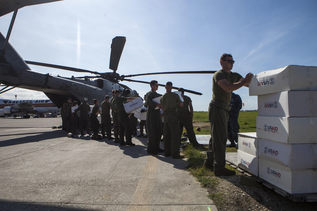 U.S. Marines with Special Purpose Marine Air-Ground Task Force-Southern Command deployed in support of Joint Task Force Matthew, load boxes from United States Agency of International Development aboard a CH-53E Super Stallion helicopter in preparation to deliver the supplies to locals affected by Hurricane Matthew at Port-au-Prince, Haiti, Oct. 10, 2016. . The supply drop operations of JTF Matthew delivered bags of rice, cooking oil and other supplies utilizing CH-53E Super Stallion and CH-47 Chinook helicopters. JTF Matthew, a U.S. Southern Command-directed team, is comprised of Marines with Special Purpose Marine Air-Ground Task Force – Southern Command and soldiers from Joint Task Force-Bravo’s 1st Battalion, 228th Aviation Regiment deployed to Port-au-Prince at the request of the Government of Haiti on a mission to provide humanitarian and disaster relief assistance in the aftermath of Hurricane Matthew.