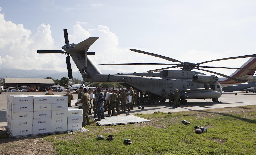U.S. Marines with Special Purpose Marine Air-Ground Task Force-Southern Command deployed in support of Joint Task Force Matthew, load boxes from United States Agency of International Development aboard a CH-53E Super Stallion helicopter in preparation to deliver the supplies to locals affected by Hurricane Matthew at Port-au-Prince, Haiti, Oct. 10, 2016. . The supply drop operations of JTF Matthew delivered bags of rice, cooking oil and other supplies utilizing CH-53E Super Stallion and CH-47 Chinook helicopters. JTF Matthew, a U.S. Southern Command-directed team, is comprised of Marines with Special Purpose Marine Air-Ground Task Force – Southern Command and soldiers from Joint Task Force-Bravo’s 1st Battalion, 228th Aviation Regiment deployed to Port-au-Prince at the request of the Government of Haiti on a mission to provide humanitarian and disaster relief assistance in the aftermath of Hurricane Matthew.