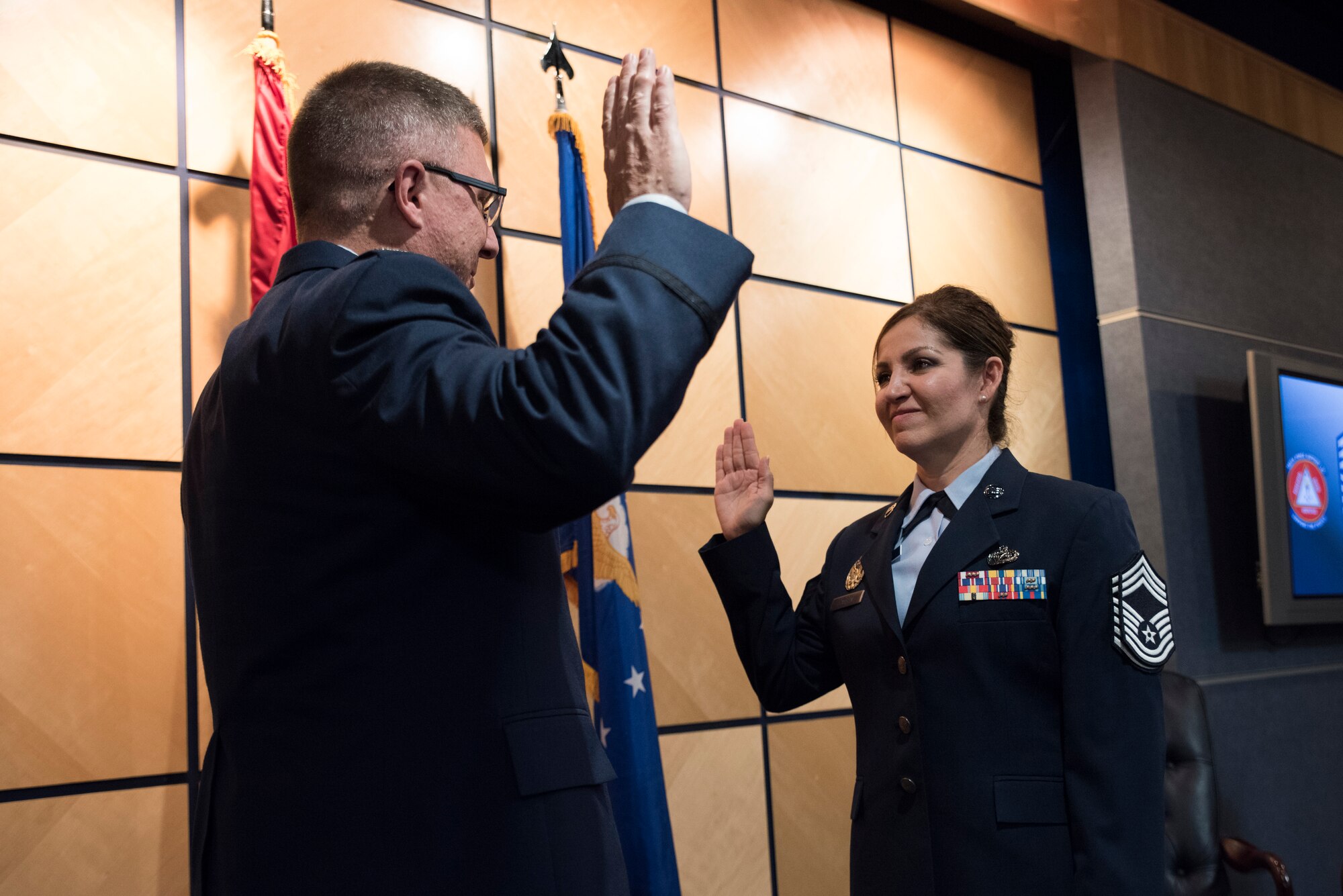 Col. Gregory Johnson, Air National Guard Advisor to the Director of Logistics, Engineering and Force Protection, swears in Chief Master Sgt. Magda Hamblin, 188th Force Support Squadron superintendent, Oct. 15, 2016, during her promotion ceremony at Ebbing Air National Guard Base, Fort Smith, Ark. As the superintendent of the ANG Readiness Center, Hamblin provided direction for the ANG Airman and Family Readiness Program Force Support Squadrons at 92 ANG Wings and more than 200 geographically separated units. (U.S. Air National Guard photo by Tech. Sgt. Daniel Condit)