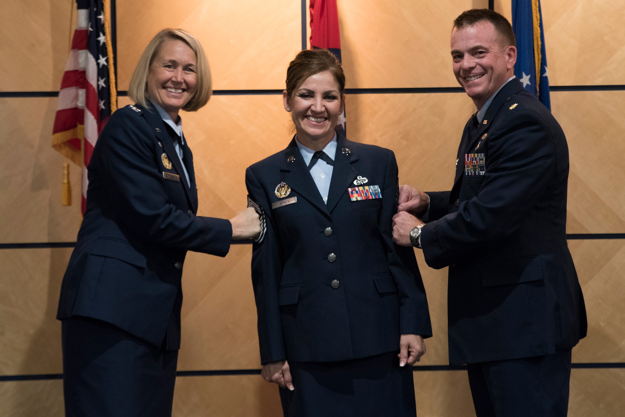 Chief Master Sgt. Magda Hamblin, 188th Force Support Squadron superintendent, has her new stripes tacked on by, from left, Col. Bobbi Doorenbos, 188th Wing commander, and Col. Gregory Johnson, Air National Guard Advisor to the Director of Logistics, Engineering and Force Protection, Oct. 15, 2016, during her promotion ceremony at Ebbing Air National Guard Base, Fort Smith, Ark. At the end of the ceremony, Hamblin presented her former senior master sergeant stripes to the lowest-ranking Airmen in the room and challenged her to succeed. (U.S. Air National Guard photo by Tech. Sgt. Daniel Condit)