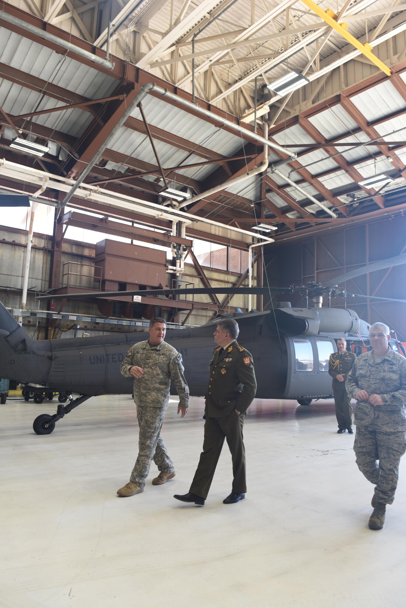 Maj. George Files (left), Army aviation support facility No. 1 maintenance officer, Pennsylvania Army National Guard, leads Lt. Gen. Jonas Vytautas Zukas, chief of defense of Lithuania, through a tour Oct. 15 of one of the aircraft hangars at Muir Army Airfield, Fort Indiantown Gap, Annville, Pa. The PANG and Lithuanian officials spent the day fostering a state-country partnership that began in 1993. (U.S. Air National Guard photo by Tech. Sgt. Claire Behney/Released)