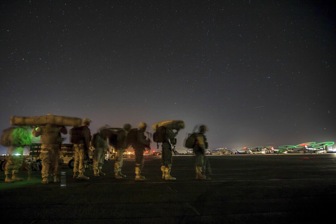 Marines wait to board a plane during Weapons and Tactics Instructor Course 1-17 at Marine Corps Air Ground Combat Center Twentynine Palms, Calif., Oct. 18, 2016. The seven-week event emphasizes operational integration of the six functions of Marine Corps aviation. Marine Corps photo by Lance Cpl. Danny Gonzalez