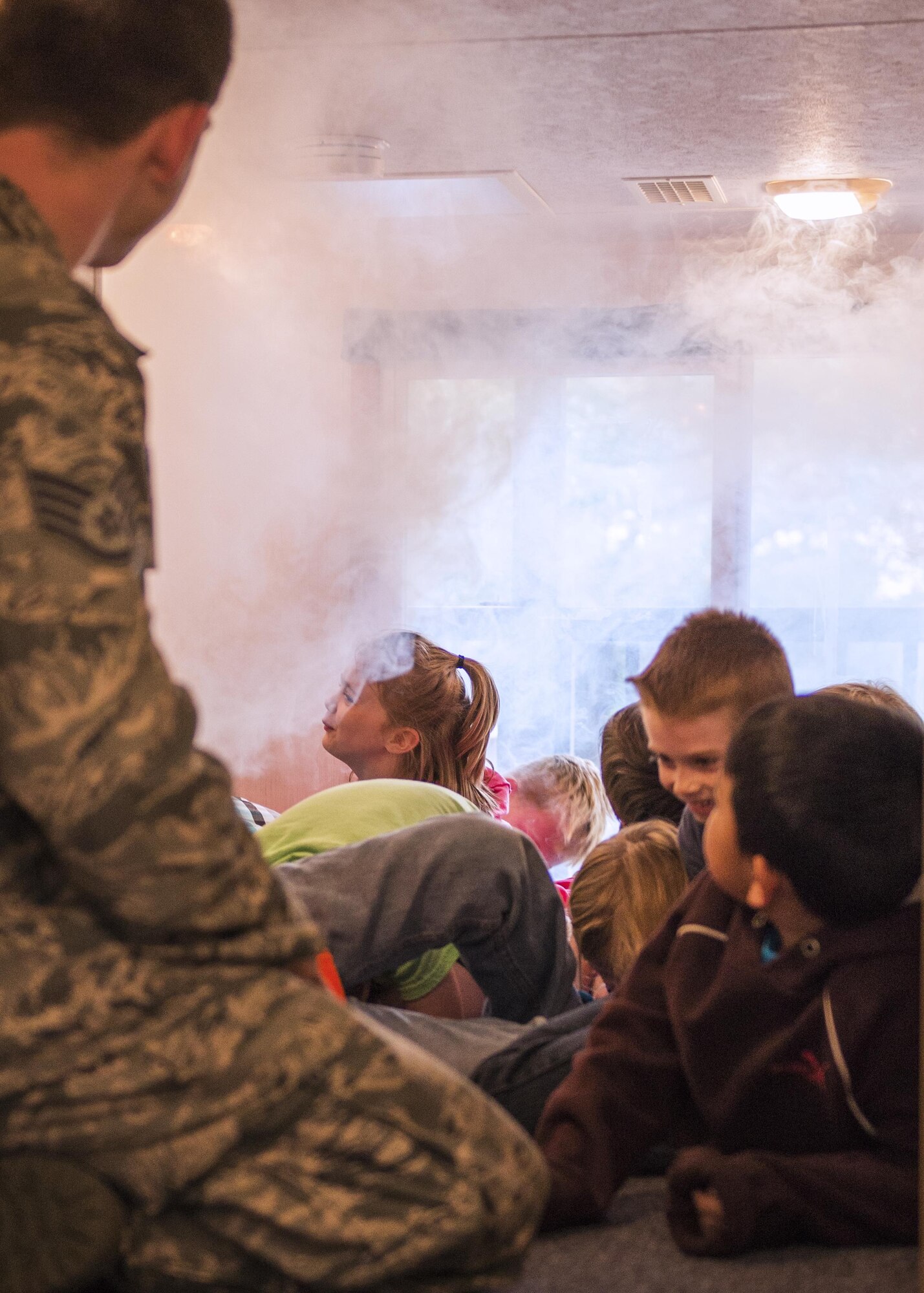 Staff Sgt. Lucas Gouldner, 374th Civil Engineer Squadron fire department fire inspector, teaches students from Joan K. Mendel elementary how to escape a building during a simulated fire on 13 Oct. 2016 at Yokota Air Base, Japan. Firefighters use Fire Prevention Week to promote fire safety and the importance of having a plan in case of a fire. (U.S. Air Force Photo by Airman 1st Class Donald Hudson/Released)