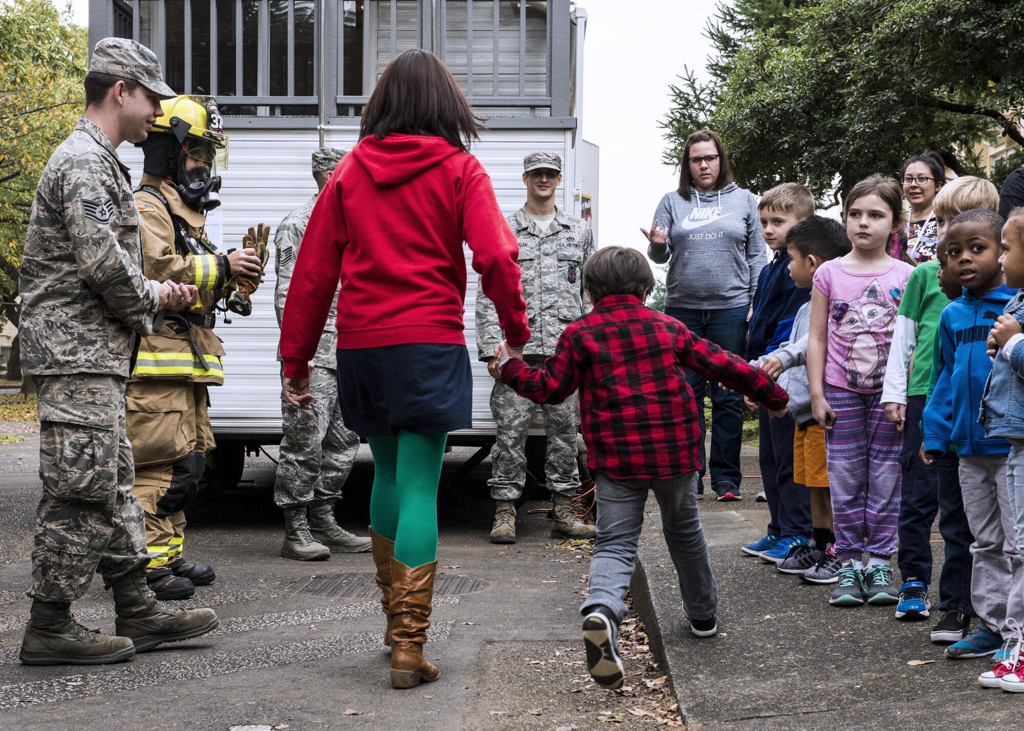 Students from Joan K. Mendel elementary school line up to learn about fire prevention during Fire Prevention Week on 13 Oct. 2016 at Yokota Air Base, Japan. Firefighters from the 374th Civil Engineer Squadron visited the elementary schools on base to demonstrate fire safety. (U.S. Air Force Photo by Airman 1st Class Donald Hudson/Released)