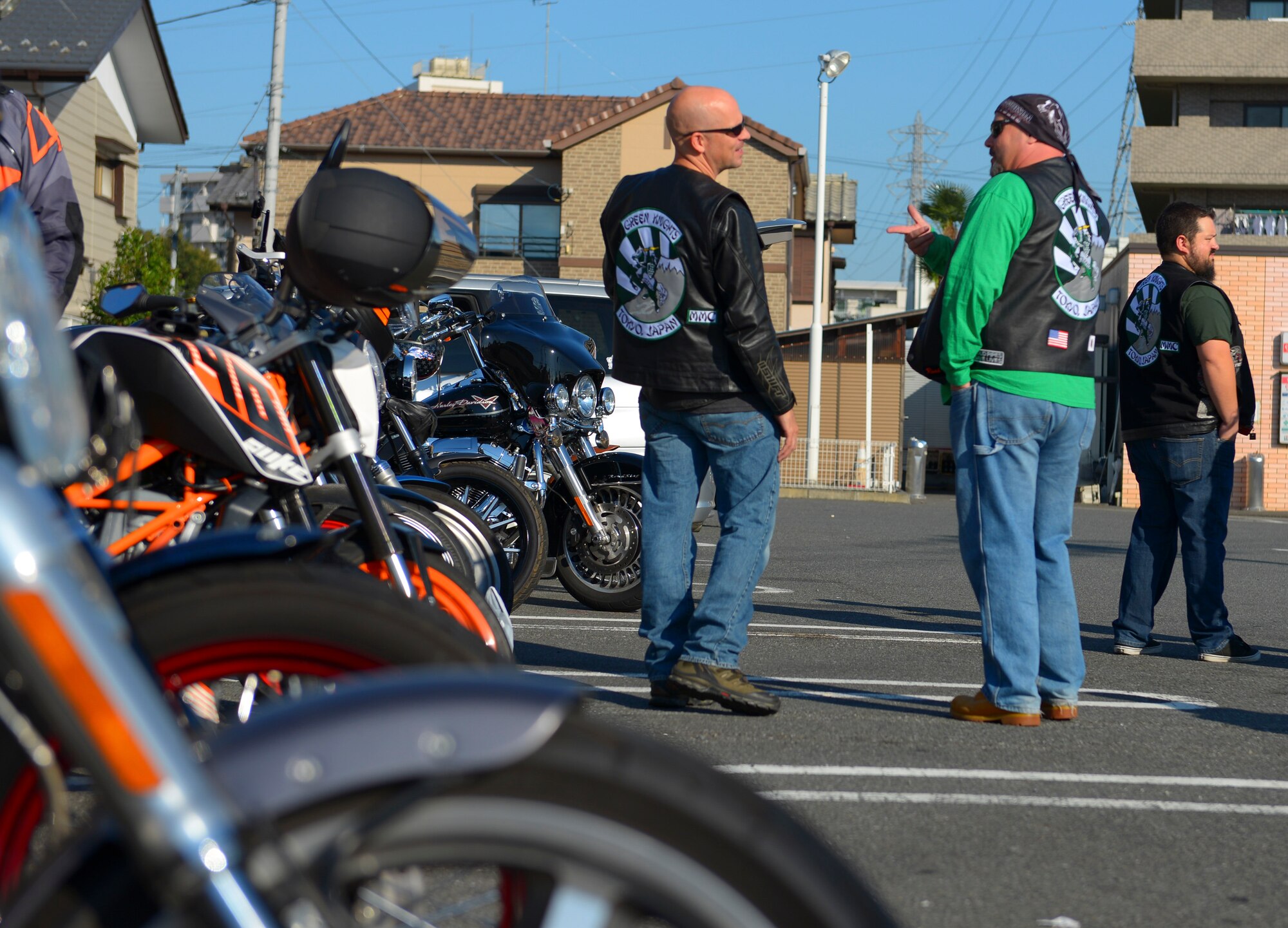 Master Sgt. Aleric Hebert, 374th Airlift Wing chaplain assistant and Nicholas Cole, 459th Airlift Squadron Uh-1 Iroquois chief mechanic, socialize before the Green Knights Military Motorcycle Club Chapter 136 inaugural breast cancer awareness ride, “Bikers for Boobies,” at Tokyo, Japan, Oct. 16, 2016. The Green Knights, a motorcycle mentorship and riding club, hosts charity events and mentorship rides to develop riding skills among motorcyclists of all levels and to give back to the community. (U.S. Air Force photo by Airman 1st Class Elizabeth Baker/Released)