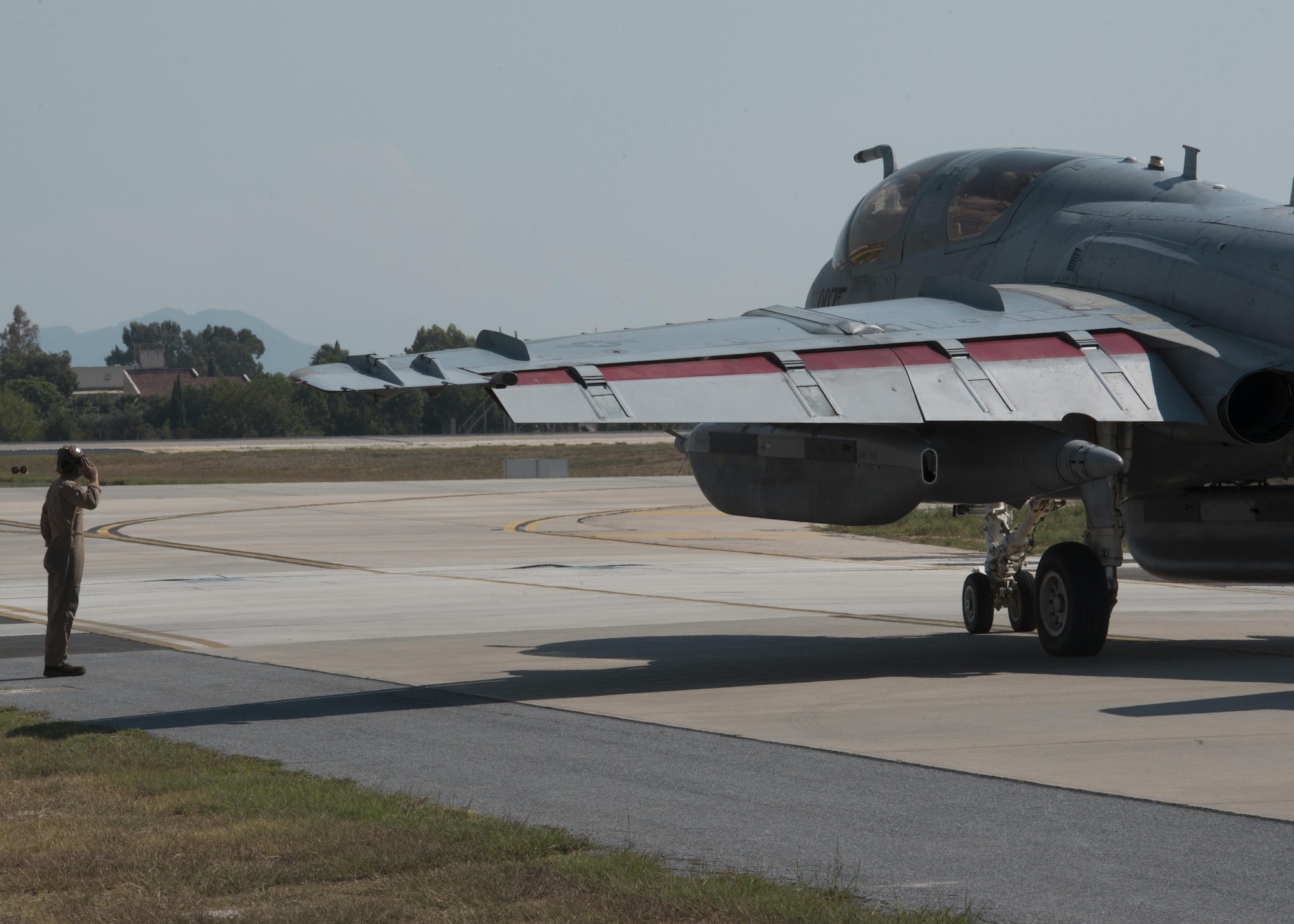 U.S. Marine Corps Cpl. Kogut Bradley, Tactical Electronic Warfare Squadron 4 plane captain, salutes an EA-6B Prowler as it taxis at Incirlik Air Base, Turkey, Sept. 16, 2016. The salute is an indication for successful launch and to pre-flight processes. (U.S. Air Force photo by Staff Sgt. Ciara Gosier)