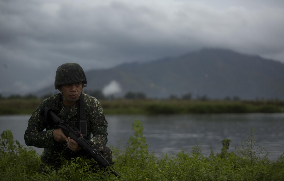 Philippine Marine Lt. Col. Erik Bautista, from Manila, Philippines, provides security on Subic Bay, Philippines, during Philippine Amphibious Landing Exercise 33 (PHIBLEX), Oct. 7, 2016. PHIBLEX is an annual U.S-Philippine military bilateral exercise that combines amphibious capabilities and live-fire training with humanitarian civic assistance efforts to strengthen interoperability and working relationships. Bautista is the battalion commander for 7th Marine Brigade. (U.S. Marine Corps photo by Lance Cpl. Nelson Duenas/Released)