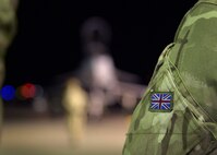 A British flag is displayed on a Royal Air Force member during the opening ceremony of exercise Guardian North 16, at Misawa Air Base, Japan, Oct. 22, 2016. More than 200 British personnel, accompanied by four Eurofighter Typhoons, a Voyager British tanker and a RAF C-17 Globemaster III, will exchange knowledge and interoperability techniques in the first-ever bilateral exercise with Japan. (U.S. Air Force photo by Senior Airman Deana Heitzman)