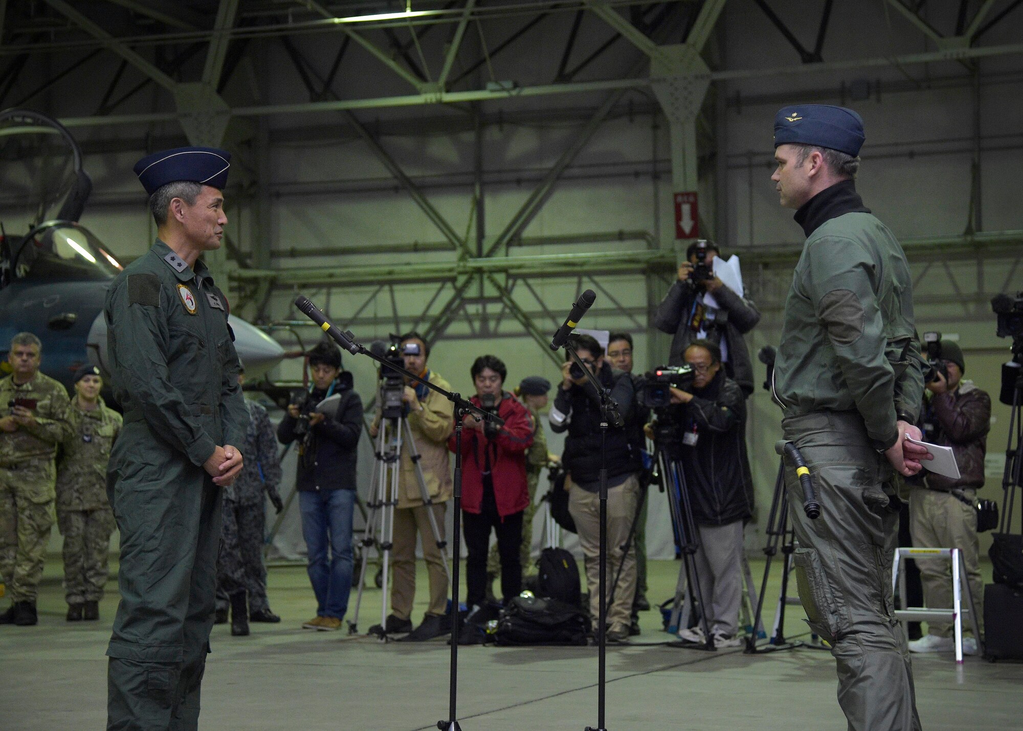 Japan Air Self-Defense Force Maj. Gen. Koji Imaki, left, 3rd Air Wing commander, welcomes Royal Air Force Wing Commander Roger Elliot, right, II Army Co-operation Squadron commanding officer RAF Lossiemouth, during the opening ceremony of exercise Guardian North 16, at Misawa Air Base, Japan, Oct. 22, 2016.  More than 200 British personnel, accompanied by four Eurofighter Typhoons, a Voyager British tanker and a RAF C-17 Globemaster III, will exchange knowledge and interoperability techniques in the first-ever bilateral exercise with Japan. RAF Lossiemouth is located in Moray, Scotland. (U.S. Air Force photo by Senior Airman Deana Heitzman)