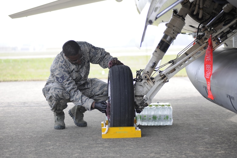 Staff Sgt. Joseph Withers, 8th Aircraft Maintenance Squadron crew chief, cleans the wheel of an F-16 Fighting Falcon at the Sacheon Airshow at Sacheon Base, Republic of Korea, Oct. 20, 2016. 7th Air Force provided both an F-16 and A-10 Thunderbolt II static display for the four-day airshow, showcasing U.S. Air Force capabilities to over 260,000 attendees. (U.S. Air Force photo by 1st Lt. Lauren Linscott/Released)
