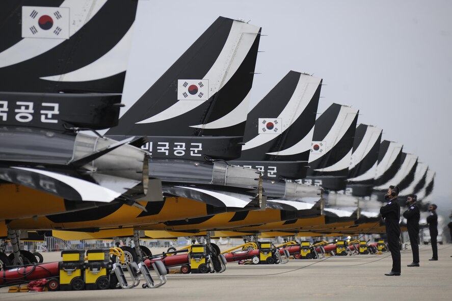 Crew chiefs for the Black Eagles demonstration team stand behind the T-50B aircraft as the pilots conduct their pre-flight checklist prior to a show at the Sacheon Airshow at Sacheon Base, Republic of Korea, Oct. 21, 2016. 7th Air Force provided both an F-16 and A-10 Thunderbolt II static display for the four-day airshow, showcasing U.S. Air Force capabilities to over 260,000 attendees. (U.S. Air Force photo by 1st Lt. Lauren Linscott/Released)