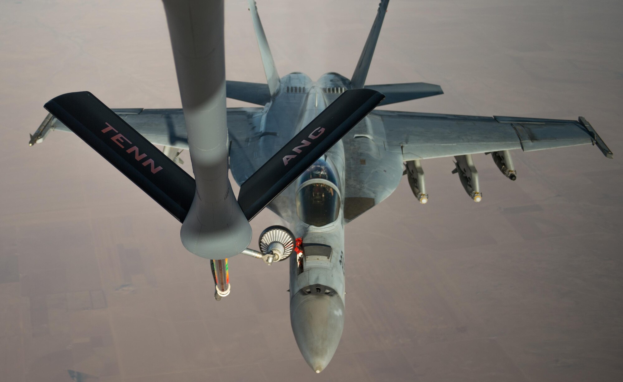 A U.S. Navy F/A-18 Super Hornet receives fuel from a KC-135 Stratotanker over Iraq in support of Operation Inherent Resolve Oct 17, 2016. The operational mission of Operation Inherent Resolve is to militarily defeat Da'esh in the Combined Joint Operation Area in order to enable whole-of-coalition governmental actions to increase regional stability. (U.S. Air Force photo by Staff Sgt. Douglas Ellis/Released)