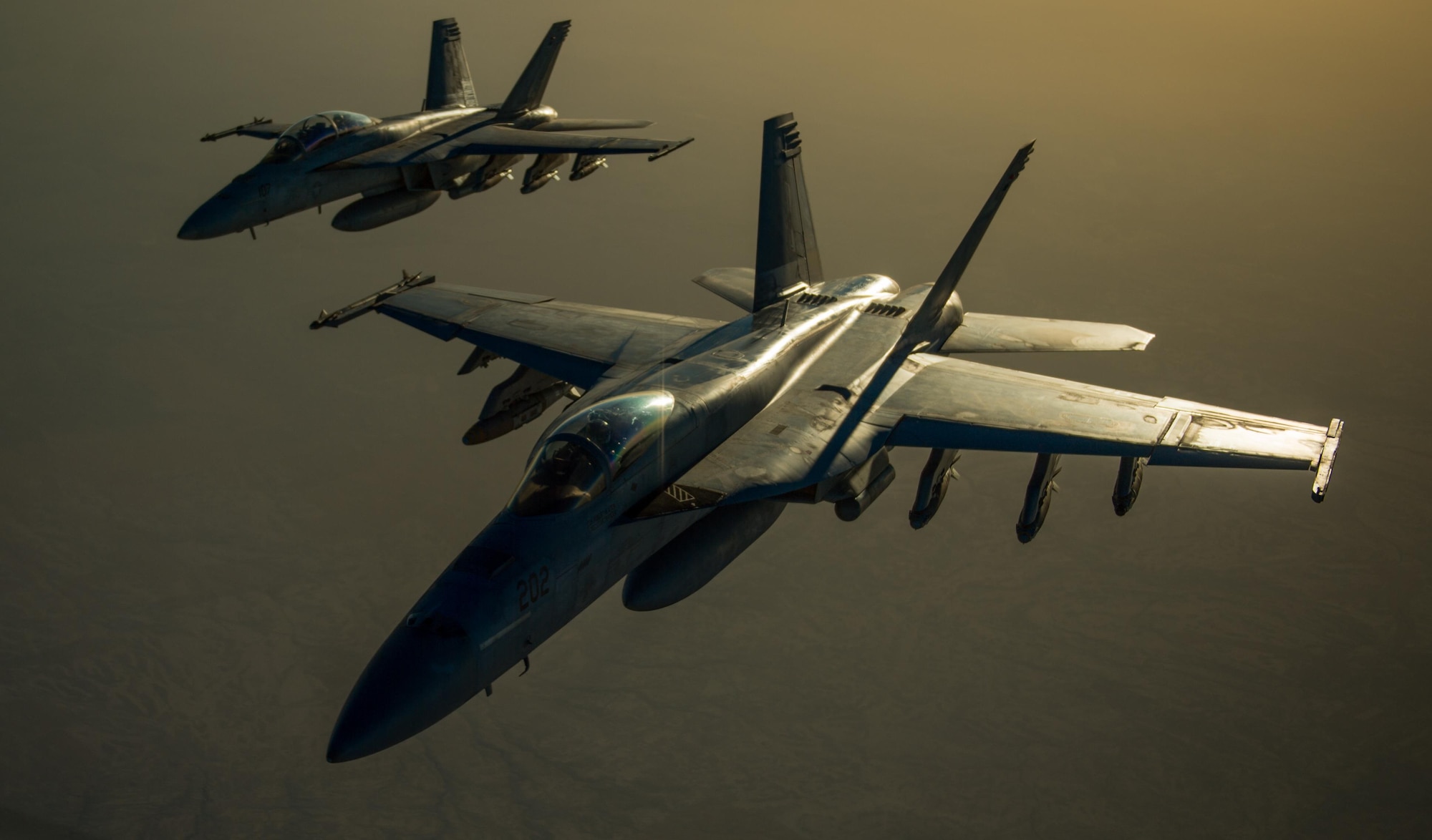 Two U.S. Navy F/A-18 Super Hornets fly in formation after receiving fuel from a KC-135 Stratotanker over Iraq in support of Operation Inherent Resolve Oct 17, 2016. The operational mission of Operation Inherent Resolve is to militarily defeat Da'esh in the Combined Joint Operation Area in order to enable whole-of-coalition governmental actions to increase regional stability. (U.S. Air Force photo by Staff Sgt. Douglas Ellis/Released)