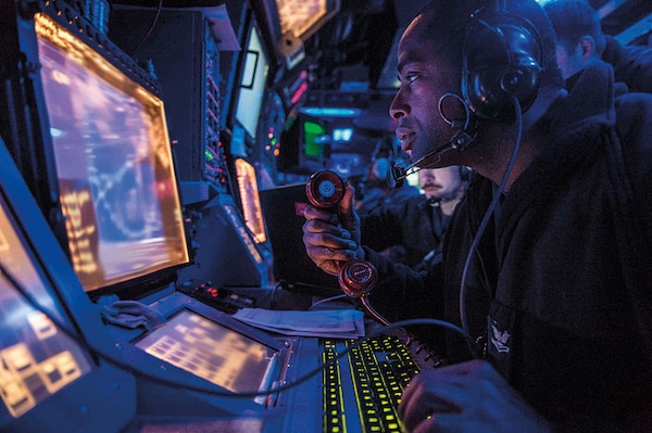 Sailor assigned to USS Mustin stands watch in ship’s combat information center during Exercise Valiant Shield 2014, which integrates about 18,000 U.S. Navy, Air Force, Army, and Marine Corps personnel, more than 200 aircraft, and 19 surface ships for real-world joint operational experience, September 16, 2014 (U.S. Navy/Declan Barnes)