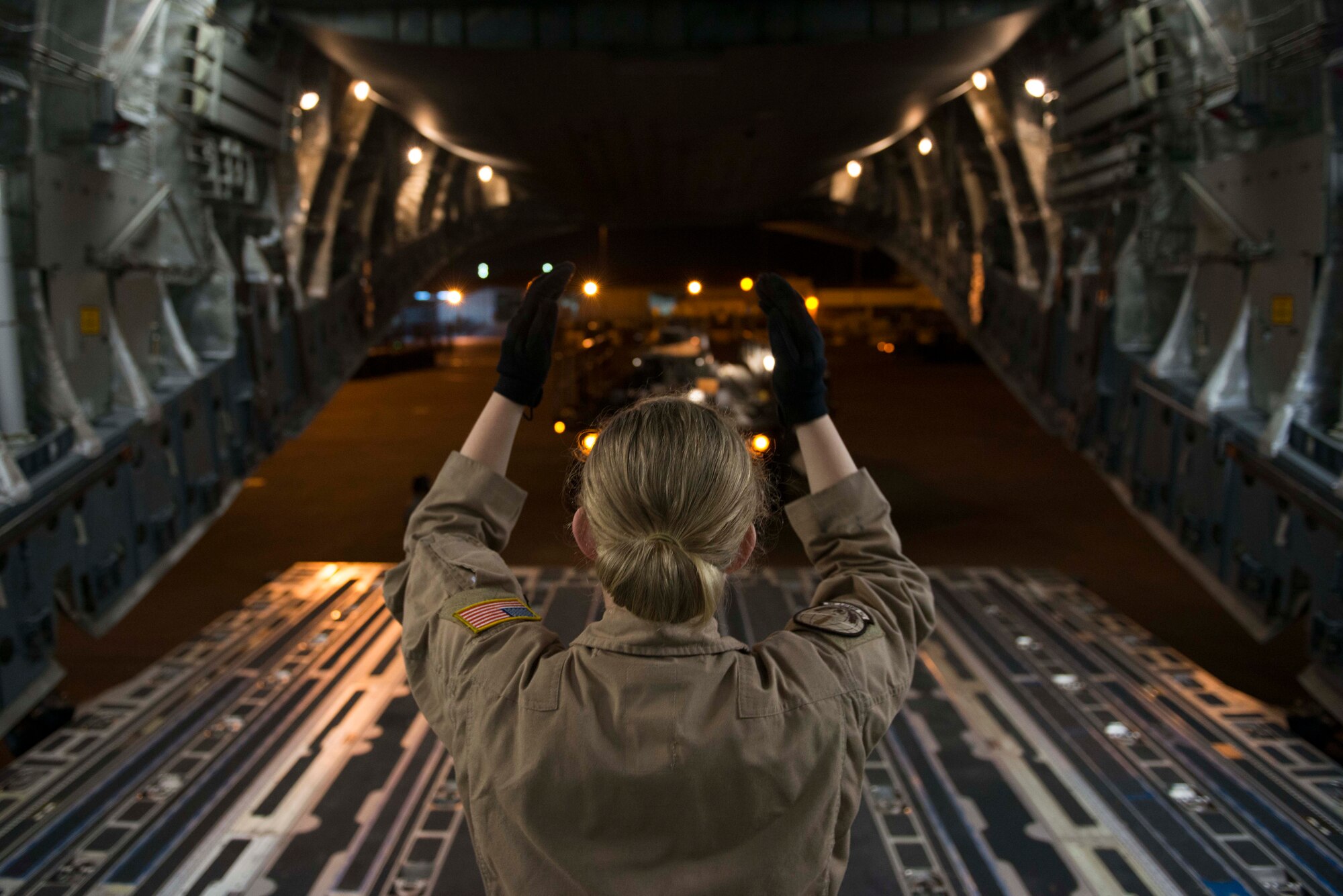 U.S. Air Force Airman 1st Class Tayler Gardner, 7th Airlift Squadron loadmaster, guides a 60K loader toward the back of a C-17 Globemaster III Oct. 21, 2016, at Incirlik Air Base, Turkey. Loadmasters supervise the loading and unloading of cargo and personnel on the aircraft. (U.S. Air Force photo by Senior Airman John Nieves Camacho)