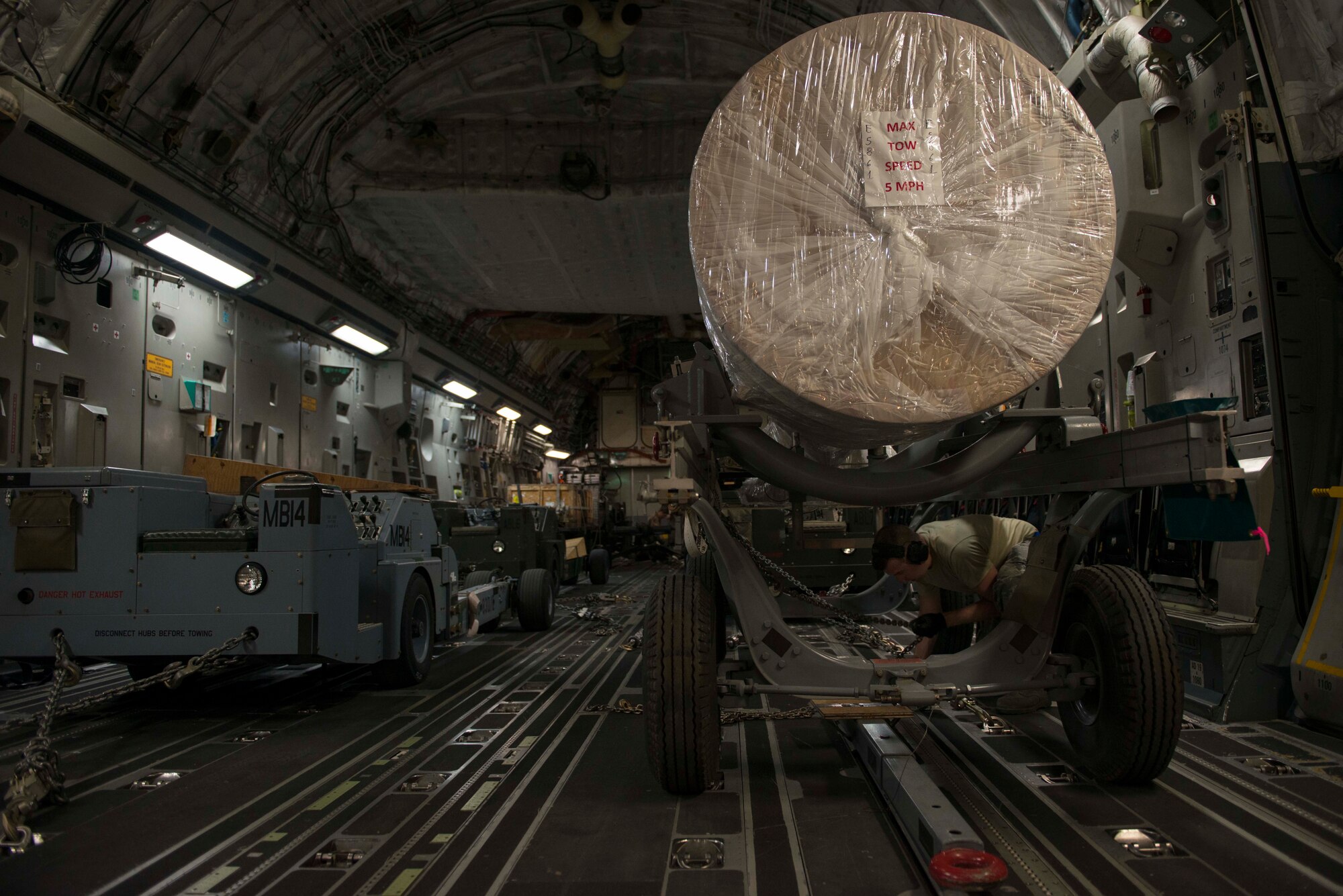 A U.S. Airman assigned to the 7th Airlift Squadron fastens cargo aboard a C-17 Globemaster III Oct. 21, 2016, at Incirlik Air Base, Turkey. C-17s can alter its cargo bay to accommodate different loads. (U.S. Air Force photo by Senior Airman John Nieves Camacho) 
