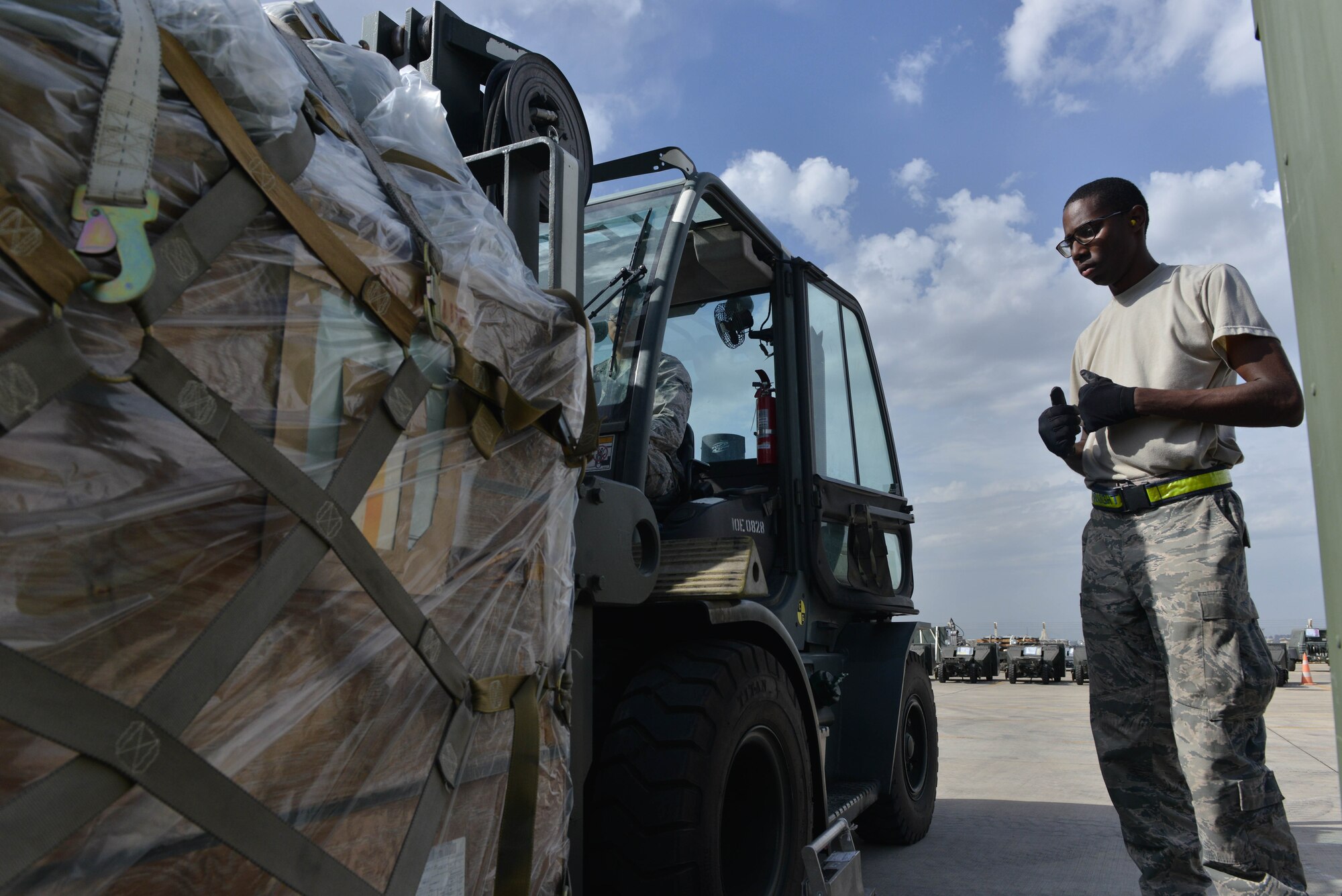 U.S. Air Force Airman Kyle George (left), 728th Air Mobility Squadron (AMS) air transportation journeyman, lifts cargo with a 10K forklift as Airman 1st Class Josiah Purnell, 728th AMS air transportation journeyman, spots him Oct. 18, 2016, at Incirlik Air Base, Turkey. The cargo contained A-10 Thunderbolt II support equipment that aids combat operations for Operation INHERENT RESOLVE. (U.S. Air Force photo by Senior Airman John Nieves Camacho)