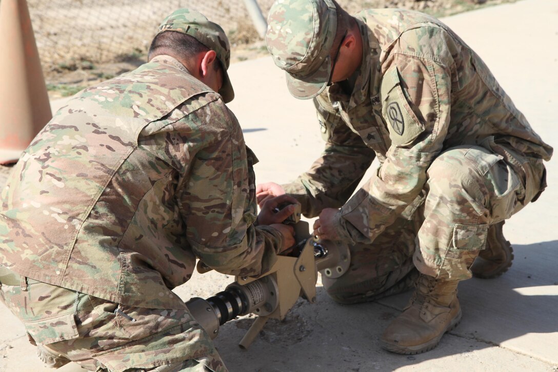 Army Reserve Sgt. Charles Smalley and Sgt. Alex Katz, both signal support systems noncommissioned officers with the 451st Expeditionary Sustainment Command, setup the equipment to install a Blue Force Tracker system on a tactical vehicle for the 300th Sustainment Brigade Det. 2, Sept. 20, 2016 at an undisclosed location in Iraq. (Army Photo by Spc. Milagro Perez)