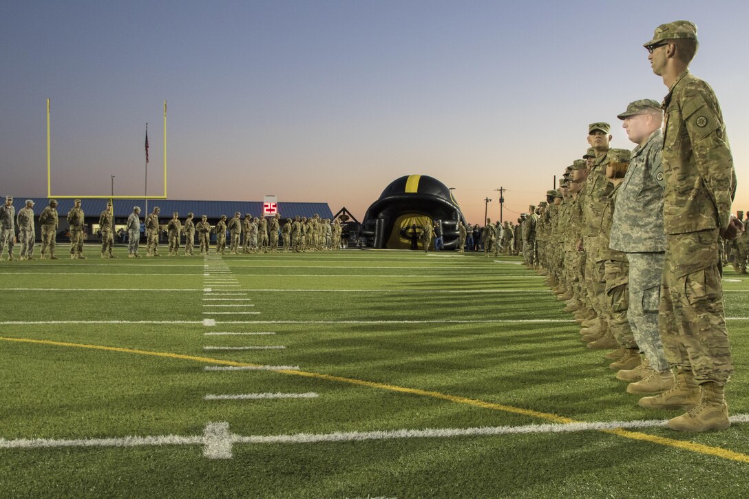 U.S. Army Reserve Soldiers create a wall for athletes of the Gatesville High School football team to run out through before a game in Gatesville, Tx., Oct. 21, 2016. (U.S. Army photo by Staff Sgt. Dalton Smith)