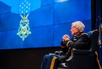 Army Lt. Col. Charles Kettles (Ret.) on stage during a visit to DLA Land and Maritime Oct. 19. Kettles was awarded the Medal of Honor July 18 for actions he performed as a helicopter pilot in Vietnam, during which he saved the lives of 44 men. 