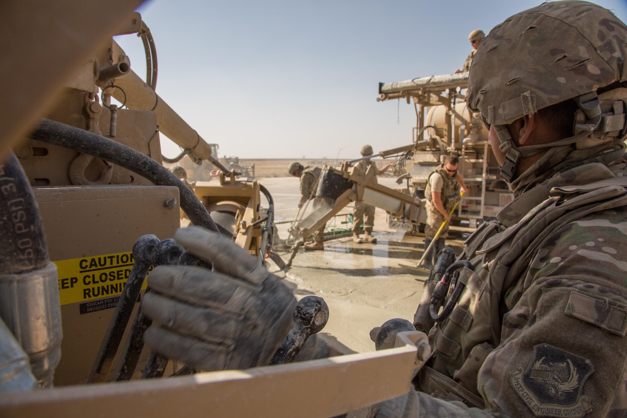 A U.S. Airman assigned to the 1st Expeditionary Civil Engineering Group operates a volumetric mixer during runway repair operations at Qayyarah West airfield, Iraq, Oct.9, 2016. 1st ECEG has been tasked with repairing the runway after the Islamic State of Iraq and the Levant (ISIL) destroyed it by using heavy machinery and explosives to disrupt Coalition forces from gaining control in the area. A Coalition of regional and international nations have joined together to enable Iraqi forces to counter ISIL, reestablish Iraq’s borders and re-take lost terrain thereby restoring regional stability and security.  (U.S. Army photo by Spc. Christopher Brecht)