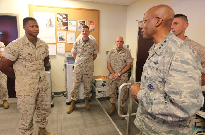 U.S. Air Force Lt. Gen. Charles Q. Brown, deputy commander, U.S. Central Command, speaks with U.S. Marine Sgt. Mathew Smith, an operations planner with U.S. Marine Corps Forces, Central Command, aboard AFB MacDill, Tampa, Fla., Oct. 4.   Brown visited the MARCENT headquarters for a brief by its commander, Lt. Gen. William D. Beydler (center) and a tour of the facility.  Smith was recognized by the CENTCOM leader for his superior performance on the job, his pursuit of a college degree, and the selfless hours of community service he has given.  (U.S. Marine Corps photo by Master Sgt. Will Price)
