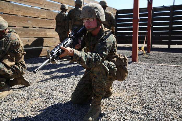 Private Shawn M. Moore, India Company, 3rd Recruit Training Battalion, provides security as his squad maneuver through an obstacle during the Crucible at Marine Corps Base Camp Pendleton, Calif., Oct. 18. Moore began training with Echo Company but was put into a Medical Holding Platoon after developing pneumonia. Moore began training again with India Company and is scheduled to graduate Oct. 28. Annually, more than 17,000 males recruited from the Western Recruiting Region are trained at MCRD San Diego.
