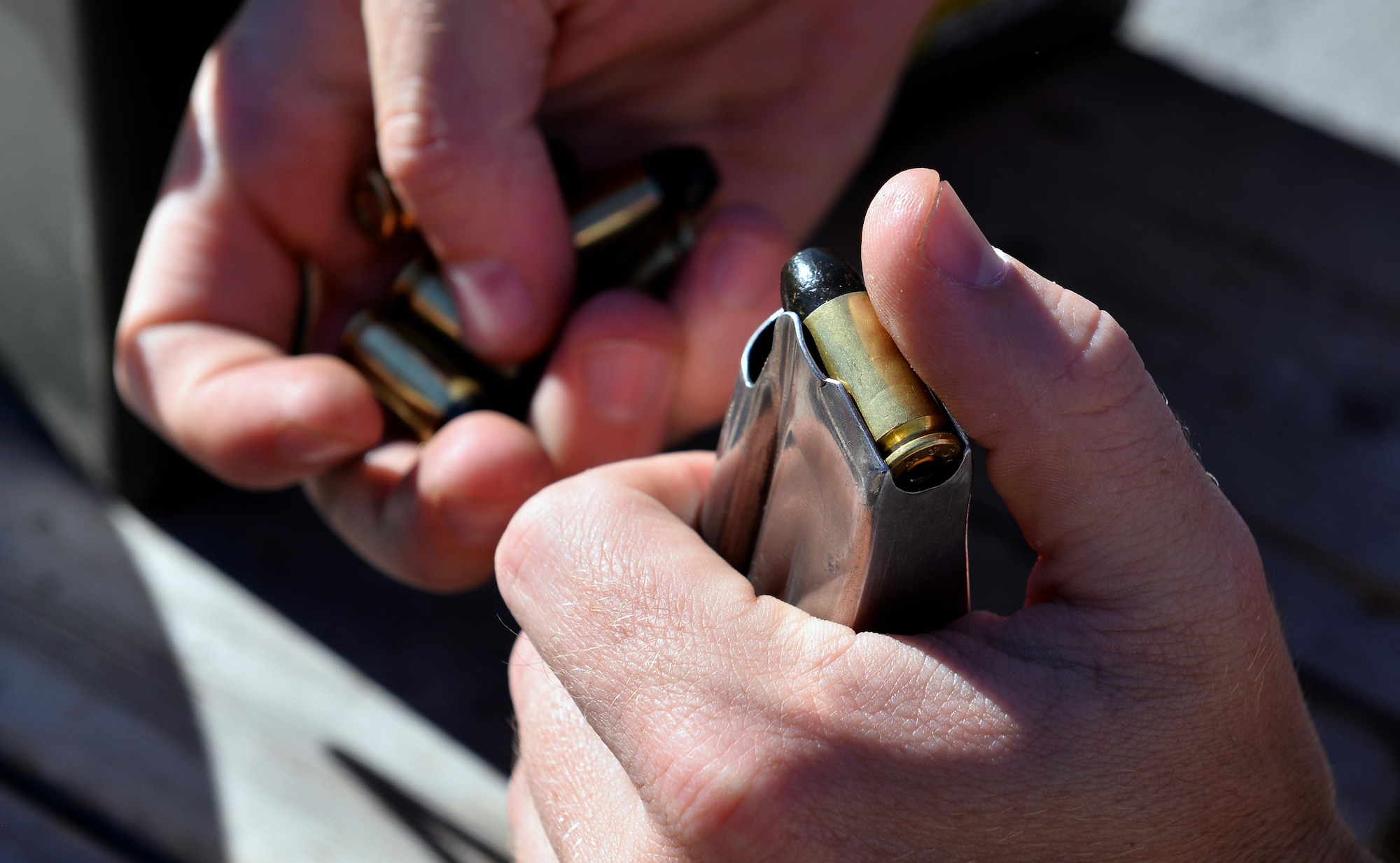 U.S. Air Force 2nd Lt. Casey Ryan, 55th Security Forces Squadron Officer-in-Charge of Logistics, loads a clip while preparing for to practice shooting targets at the Eastern Nebraska Gun Club on Sept. 28 in Louisville, Neb.  Ryan is a member of the U.S. Air Force competition shooting team.  (U.S. Air Force photo by Josh Plueger)