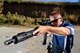 U.S. Air Force 2nd Lt. Casey Ryan, 55th Security Forces Squadron Officer-in-Charge of Logistics, takes aim at knockdown plate targets set up at the Eastern Nebraska Gun Club on Sept. 28 in Louisville, Neb.  Ryan is a part of the official Air Force competition shooting team.  (U.S. Air Force photo by Josh Plueger)