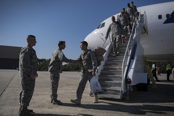 Airmen assigned to the 822d Base Defense Squadron are greeted by Col. Bradley Smith, 93d Air Ground Operations Wing vice commander, and Col. Kevin Walker, 820th Base Defense Group commander, Oct. 21, 2016, at Moody Air Force Base, Ga. These Airmen were tasked with securing expeditionary stations and assets in Southwest Asia. (U.S. Air Force photo by Airman 1st Class Daniel Snider)