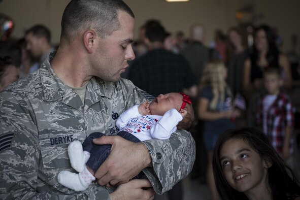 Staff Sgt. Brandon Deryke, 822d Base Defense Squadron NCO in charge of combat arms, greets his family after returning from a deployment to Southwest Asia, Oct. 21, 2016, at Moody Air Force Base, Ga. The 822d is one of three base defense squadrons stationed at Moody that cycles through rotational deployments to secure overseas assets. (U.S. Air Force photo by Airman 1st Class Daniel Snider)