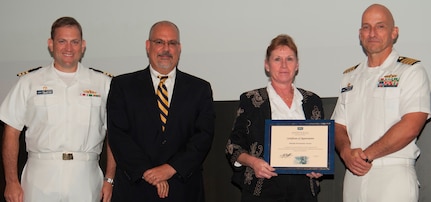 Michelle Turner receives her certificate of appreciation from Naval Surface Warfare Center Dahlgren Division (NSWCDD) Technical Director John Fiore, NSWCDD Commanding Officer Capt. Brian Durant, right, and Combat Direction Systems Activity Dam Neck Commanding Officer Cmdr. Andrew Hoffman at the 2016 NSWCDD academic awards ceremony. Turner was recognized for completing her system safety certification from the University of Southern California, and commended for her commitment to personal and professional development. 