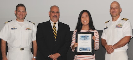 Sarah Kim receives her certificate of achievement from Naval Surface Warfare Center Dahlgren Division (NSWCDD) Technical Director John Fiore, NSWCDD Commanding Officer Capt. Brian Durant, right, and Combat Direction Systems Activity Dam Neck Commanding Officer Cmdr. Andrew Hoffman at the 2016 NSWCDD academic awards ceremony. Kim was recognized for completing her master's degree in operations research from George Mason University, and commended for her commitment to personal and professional development.