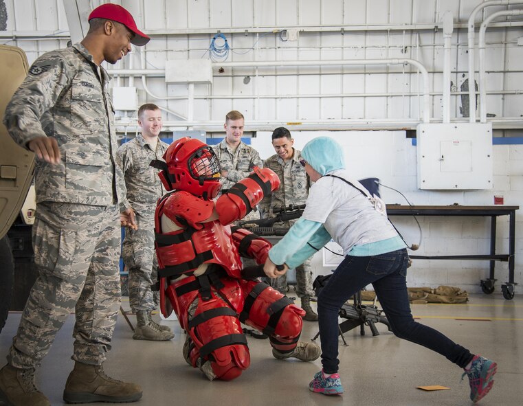 A new recruit attacks the Redman at a security forces demonstration during the Operation Hero event Oct. 22 at Eglin Air Force Base, Fla.  More than 100 kids participated in the mock deployment experience created to give military children a glimpse of what their loved ones go through when they leave home. The kids went through a deployment line to get their dog tags and “immunizations” before they were briefed by the commander and shipped off to a deployed location. There, they participated in various activities and demonstrations by local base agencies. (U.S. Air Force photo/Samuel King Jr.)