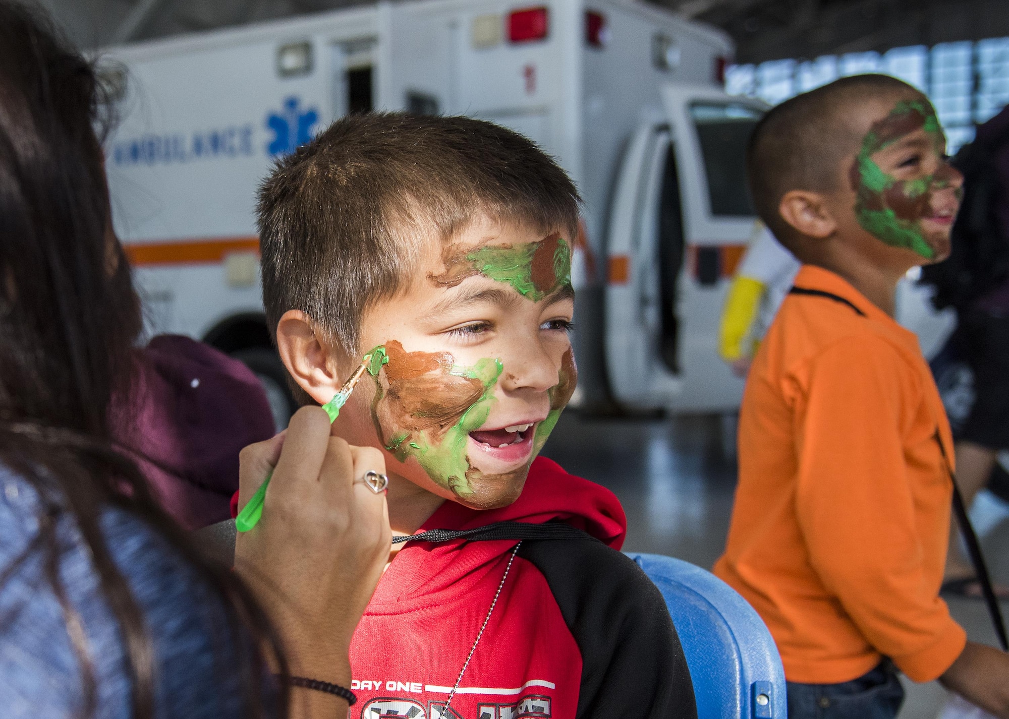 A new recruit gets his war paint applied during the Operation Hero event Oct. 22 at Eglin Air Force Base, Fla.  More than 100 kids participated in the mock deployment experience created to give military children a glimpse of what their loved ones go through when they leave home. The kids went through a deployment line to get their dog tags and “immunizations” before they were briefed by the commander and shipped off to a deployed location. There, they participated in various activities and demonstrations by local base agencies. (U.S. Air Force photo/Samuel King Jr.)