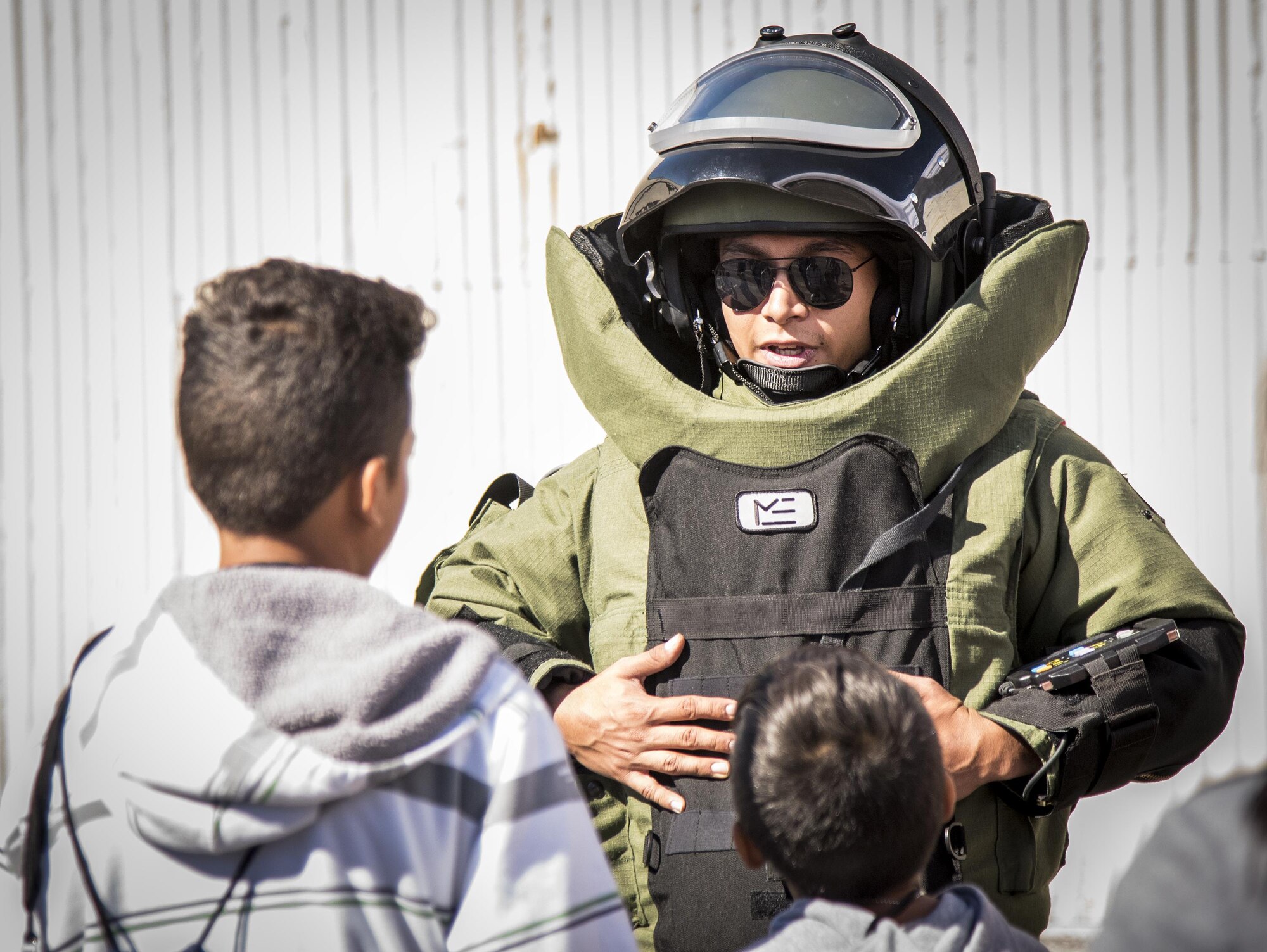An Airman explains the explosive ordnance disposal bomb suit to a couple of recruits during the Operation Hero event Oct. 22 at Eglin Air Force Base, Fla.  More than 100 kids participated in the mock deployment experience created to give military children a glimpse of what their loved ones go through when they leave home. The kids went through a deployment line to get their dog tags and “immunizations” before they were briefed by the commander and shipped off to a deployed location. There, they participated in various activities and demonstrations by local base agencies. (U.S. Air Force photo/Samuel King Jr.)
