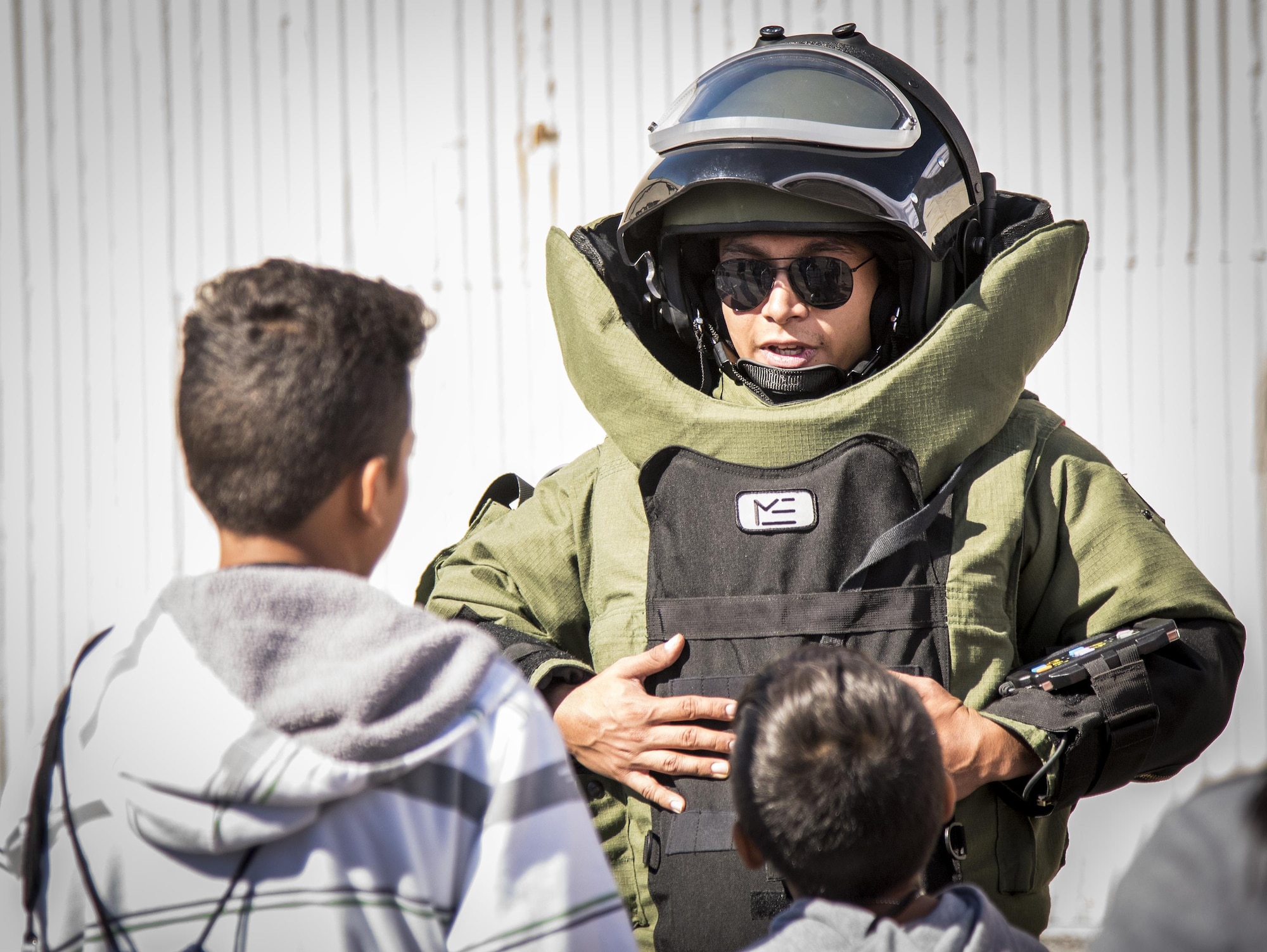 An Airman explains the explosive ordnance disposal bomb suit to a couple of recruits during the Operation Hero event Oct. 22 at Eglin Air Force Base, Fla.  More than 100 kids participated in the mock deployment experience created to give military children a glimpse of what their loved ones go through when they leave home. The kids went through a deployment line to get their dog tags and “immunizations” before they were briefed by the commander and shipped off to a deployed location. There, they participated in various activities and demonstrations by local base agencies. (U.S. Air Force photo/Samuel King Jr.)