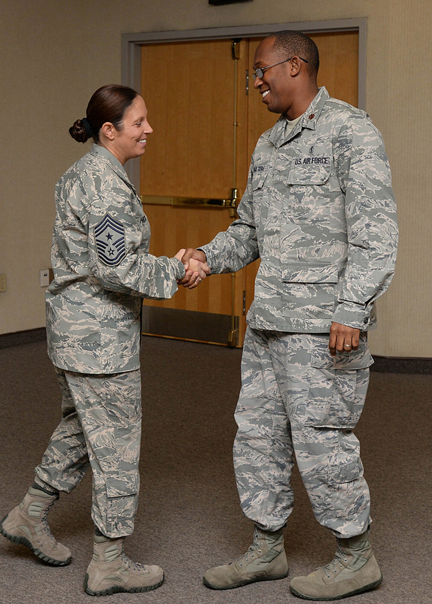Hanscom Command Chief Master Sgt. Patricia L. Hickey congratulates Maj. Edward B. Walters, commander of the Aerospace and Operational Medicine Flight, on winning the 66th Air Base Group Field Grade Officer of the Quarter during the group's quarterly awards program at the conference center Oct. 24. Col. Roman L. Hund and Hickey presented 10 Airmen and one team with quarterly awards for the third quarter. (U.S. Air Force photo by Linda LaBonte Britt)