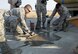 A concrete taxiway repair is completed by Airmen assigned to the 60th Air Mobility Wing at Travis Air Force Base, Calif., Aug. 19, 2016. Using similar techniques on a much larger scale in 2016, members of the 1st Expeditionary Civil Engineer Group repaired runway damage caused by Islamic State of Iraq and the Levant at Qayyarah West Airbase in northern Iraq’s Ninawa province. (U.S. Air Force photo/Heide Couch)