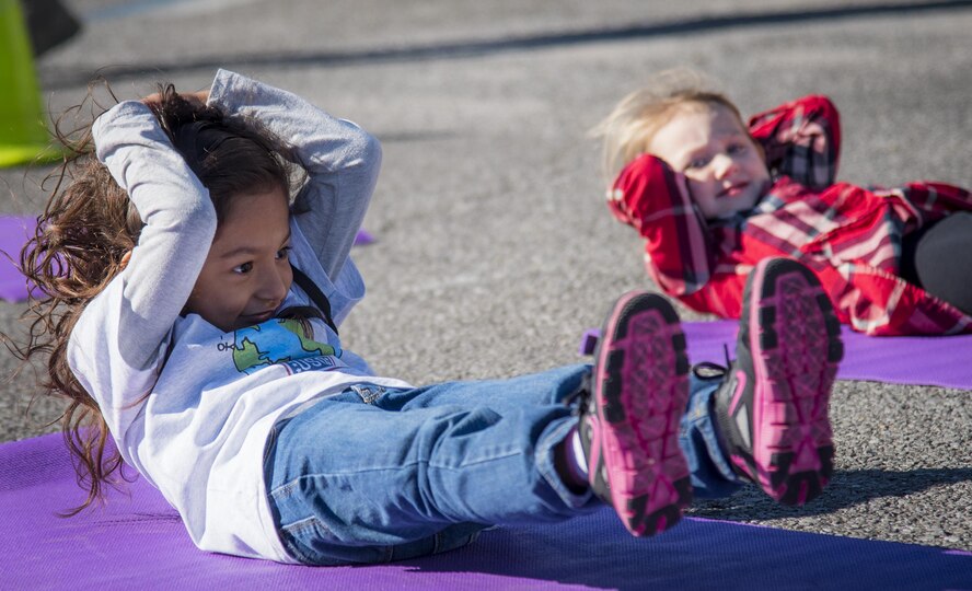 A new recruit strains for one more sit up during the Operation Hero event Oct. 22 at Eglin Air Force Base, Fla.  More than 100 kids participated in the mock deployment experience created to give military children a glimpse of what their loved ones go through when they leave home. The kids went through a deployment line to get their dog tags and “immunizations” before they were briefed by the commander and shipped off to a deployed location. There, they participated in various activities and demonstrations by local base agencies. (U.S. Air Force photo/Samuel King Jr.)