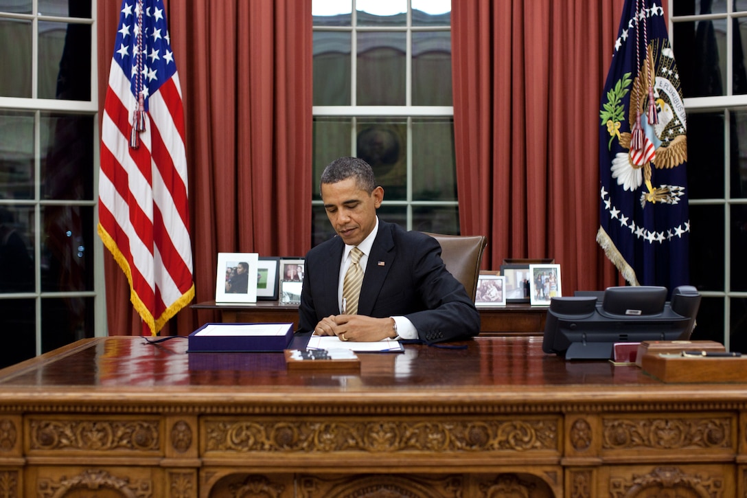 President Barack Obama signs a document at the White House, Feb. 22, 2012. White House photo by Pete Souza