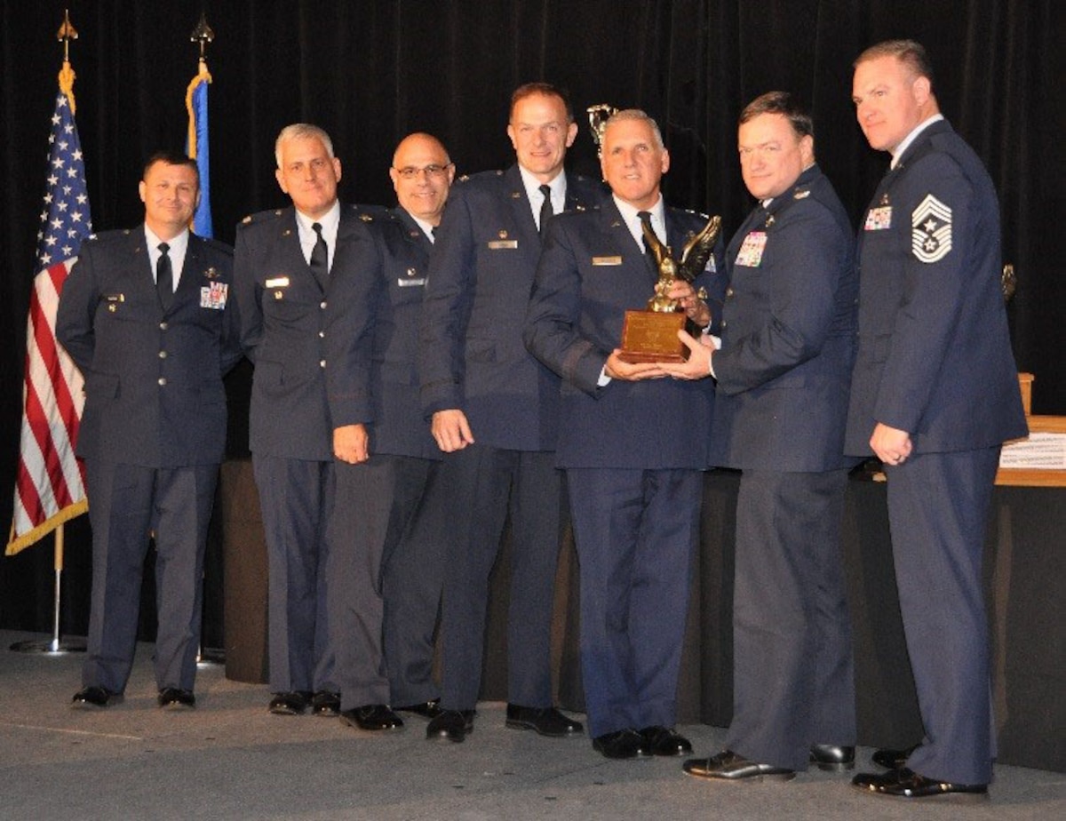 Representatives from the 514th Air Mobility Wing, Joint Base McGuire-Dix-Lakehurst, New Jersey, accept the 2016 Aircrew Excellence Award on behalf of their 732nd Airlift Squadron aircrew at the 17th Annual Raincross Dinner in Riverside, California, Oct. 20, 2016. From left are Col. Lee Merkle, director, Air and Space Operations, Plans and Programs, 4th Air Force; Lt. Col. Rustin Redlin, deputy commander, 514th Mission Support Group; Col. Anthony Esposito, commander, 514th Maintenance Group; Col. Robert Dunham, commander, 514th Operations Group; Maj. Gen. John C. Flournoy Jr., commander, 4th Air Force; Col. David Pavey, commander, 514 AMW; Chief Master Sgt. Matthew Muldowney, command chief, 514 AMW. (U.S. Air Force photo/Linda Welz)